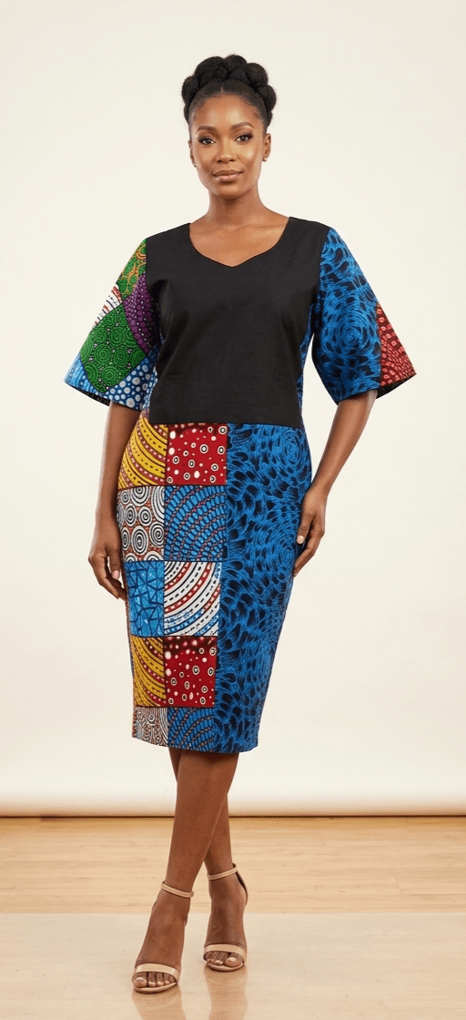 Couture color-blocked midi dress featuring a solid black bodice panel juxtaposed with bespoke patchwork Ankara textiles, showcasing vividly contrasting geometric prints on the wide sleeves and tailored skirt.